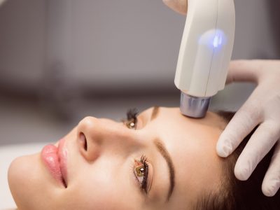 Female patient receiving cosmetic treatment at clinic