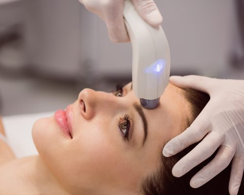 Female patient receiving cosmetic treatment at clinic